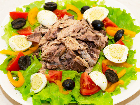 Delicious salad with tuna, tomatoes, eggs, olives and peppers.