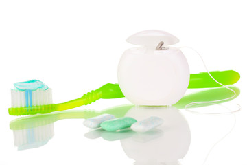 Toothbrush, chewing gum and dental floss isolated on white