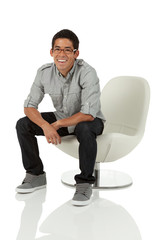 College age man sitting in a modern chair