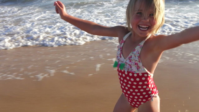 Little Girl Running Along Beach