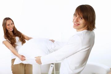 Obraz premium Young couple fighting with pillows