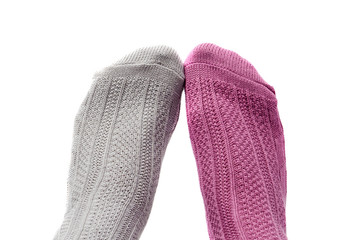feet with socks of different colors, pink and gray, isolated