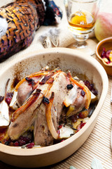 baked pheasant with bacon, pear, raisins on brandy