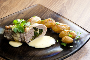 baked pork tenderloin filled with spinach and goat cheese on cre