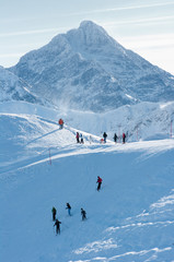 People on the snow-covered mountain peaks and rocky peaks.