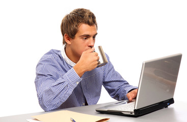 A young businessman having a cup of coffee