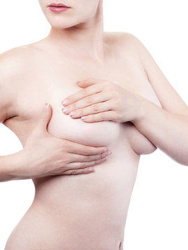 Young woman examining her breasts - isolated