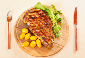 Ribeye steak with fresh greenery and tomatoes
