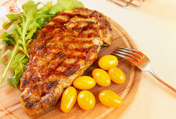 Ribeye steak with greenery and tomatoes