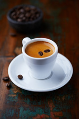 Cup of espresso with coffee beans