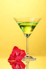 glass with cocktail and gladiolus bud
