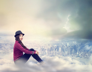 Fototapeta na wymiar Happy Woman Sitting on the Clouds
