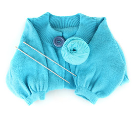 Blue sweater and a ball of wool isolated on white