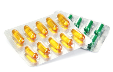 Capsules packed in blisters, isolated on white