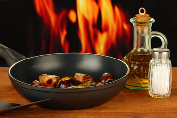 roasted chestnuts in the pan and decanter with oil, salt and