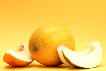 ripe sweet melons, on yellow background