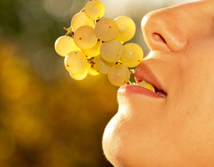 Woman eats grapes