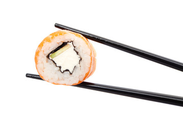 Sushi roll with black chopsticks, isolated on white
