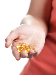 Fototapeta premium Pills on the hand, isolated on white. Herbal remedy