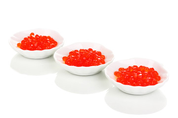 Red caviar in white bowls isolated on white