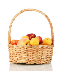 Ripe fruit in basket isolated on white