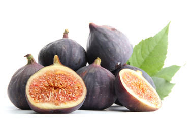 Ripe sweet figs with leaves isolated on white