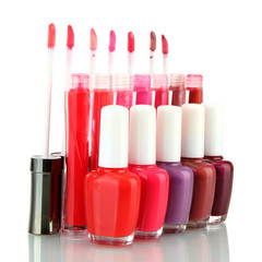 beautiful lip glosses and nail polish bottles, isolated on