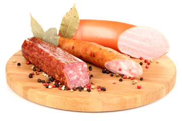 Tasty sausage on chopping board isolated on white