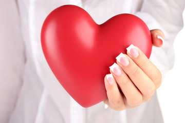 Red heart in woman's hand, on white background close-up