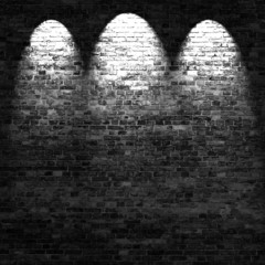 dark brick wall background in basement with beams of light