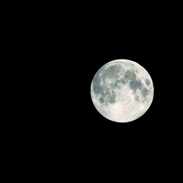 full moon on dark sky, isolated on black