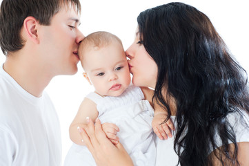 Happy parents kissing baby