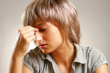 A woman having a headache, closeup