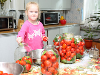 Child  preparing canned tomatoes