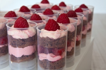 Push up cake pop with raspberry and chocolate bisquit on stand
