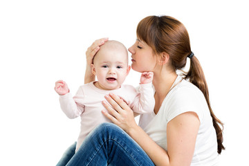 happy mother kissing her baby girl