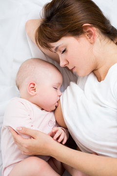 relaxed mother breast feeding her baby girl