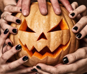evil pumpkin with glowing eyes that are holding