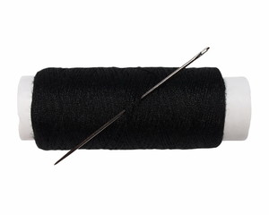 Macro black bobbin with needle isolated on white