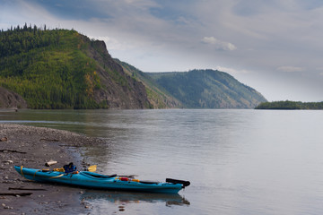 Kayak beached on the shore of Yukon River Canada