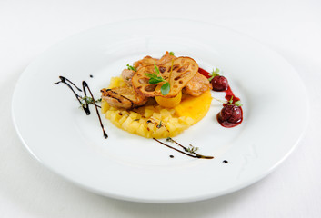 Juicy roasted chicken with pumpkin on a plate