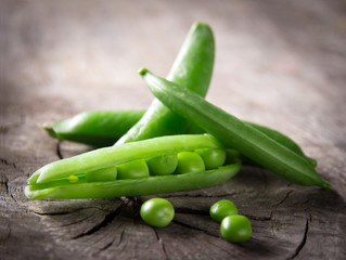 Fresh peas on wooden table