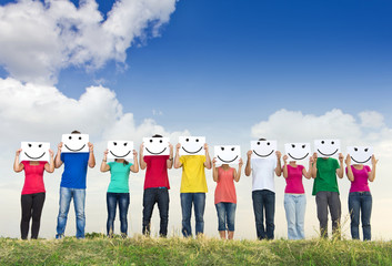 Group of young people holding papers with smileys