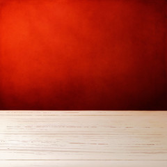 Background with white wooden table and grunge red wall
