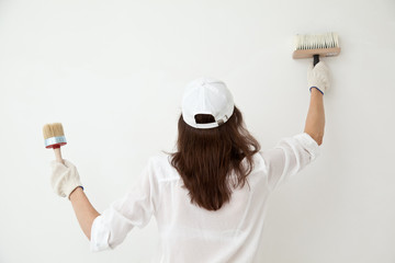Woman painting the wall