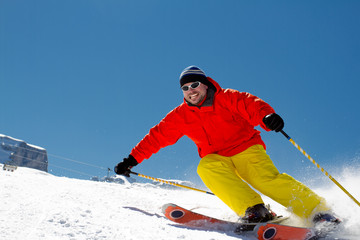 Freeride in fresh powder snow - man skiing downhill