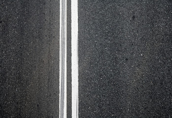 Close-up texture of an asphalt road with marking
