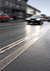 On the wet road with fast approaching cars