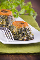Spinach cakes on white dish.