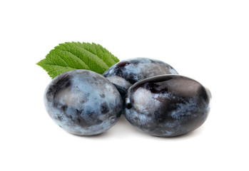 Three ripe plums with leave